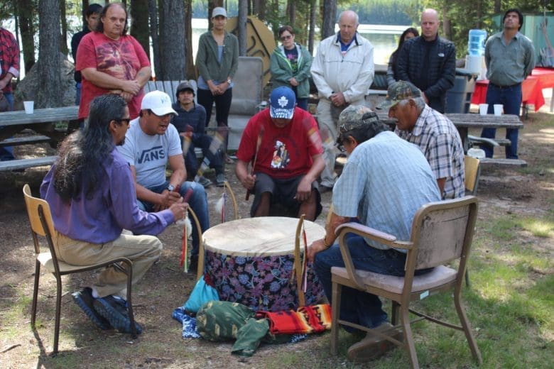 first nations people around a drum in ceremony in Northern Ontario