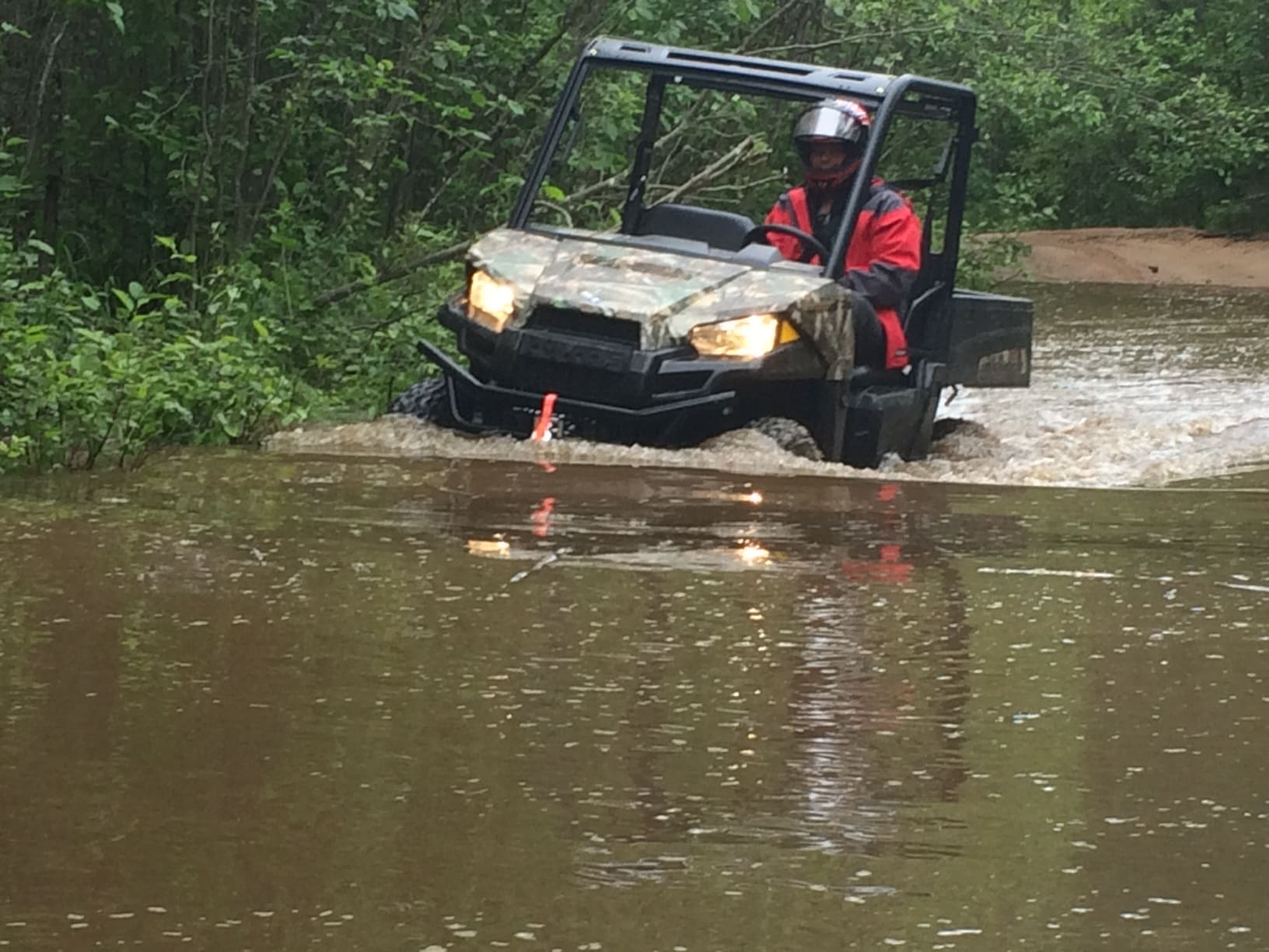 IISD-ELA Operations Manager Mark Lyng driving the Ranger Li-ion EV through water