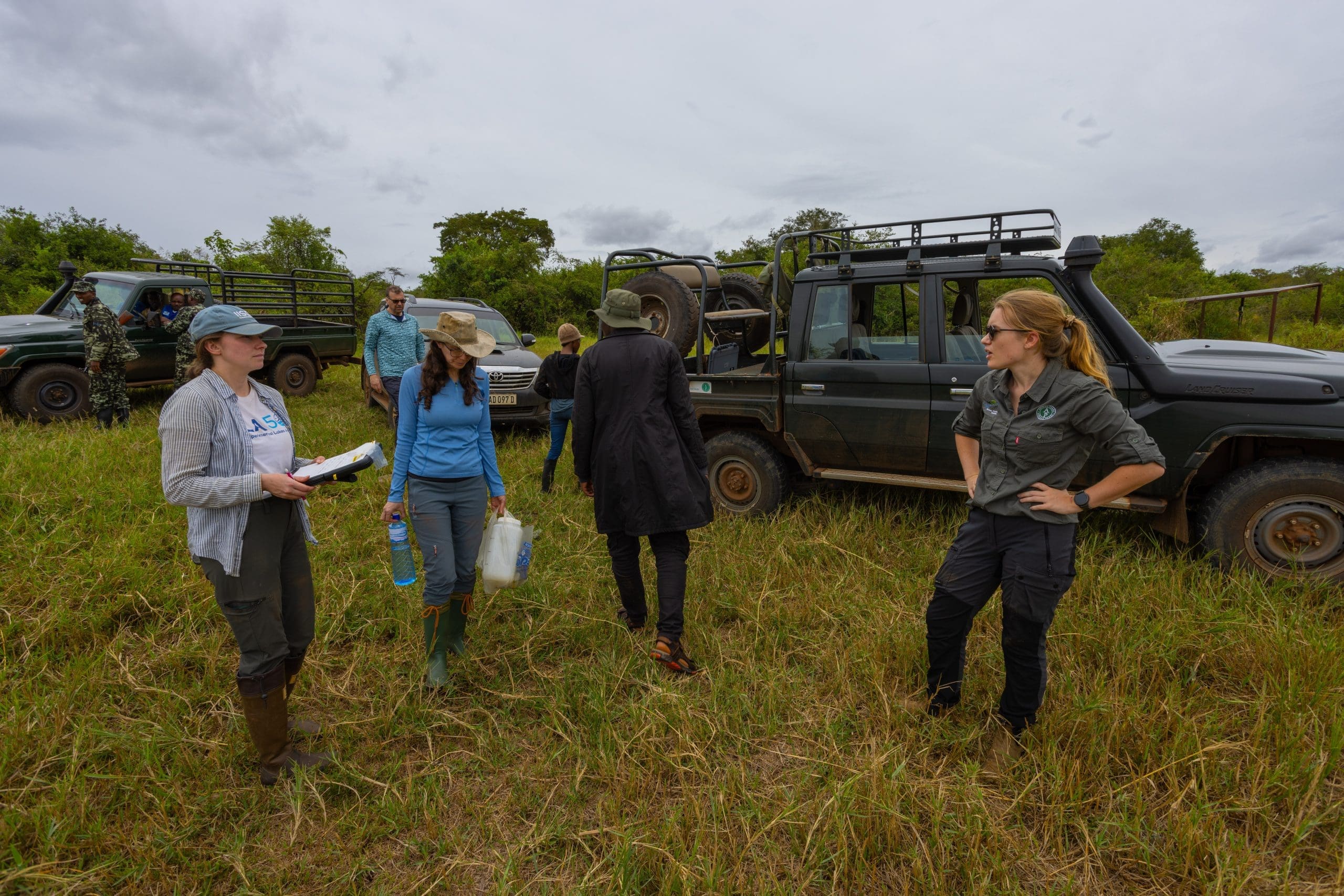 Desiree Langenfeld, Chelsea Rochman and Emma Evers discuss the day's plan of action before heading off sampling lakes in Akagera National Park.