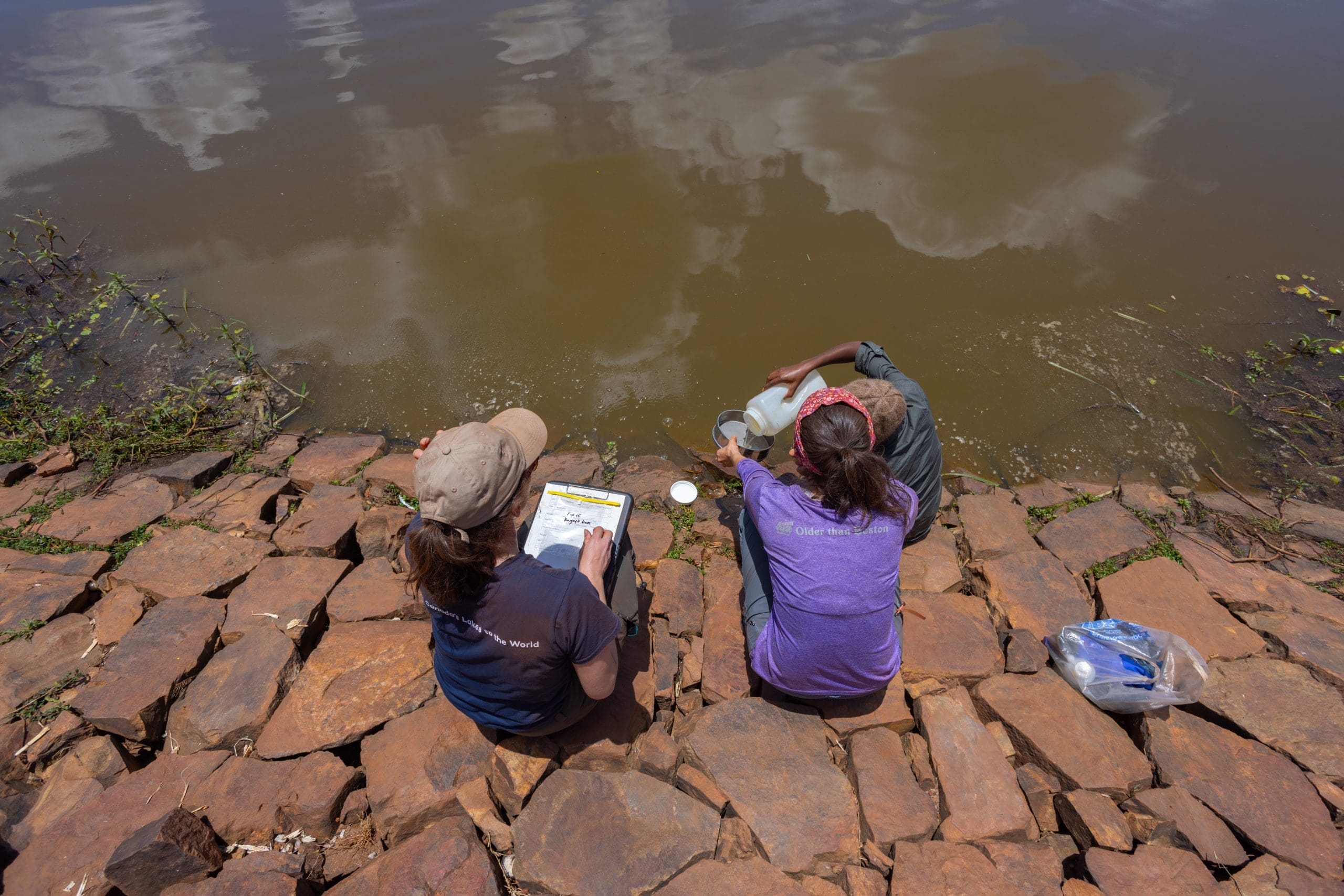 Teamwork makes the dream work. Collecting more microplastics from on a dam in a village. We're collecting from outside the park to see if the wetlands within the park are performing any sort of filtration and settling effect to clean the river as it passes through.